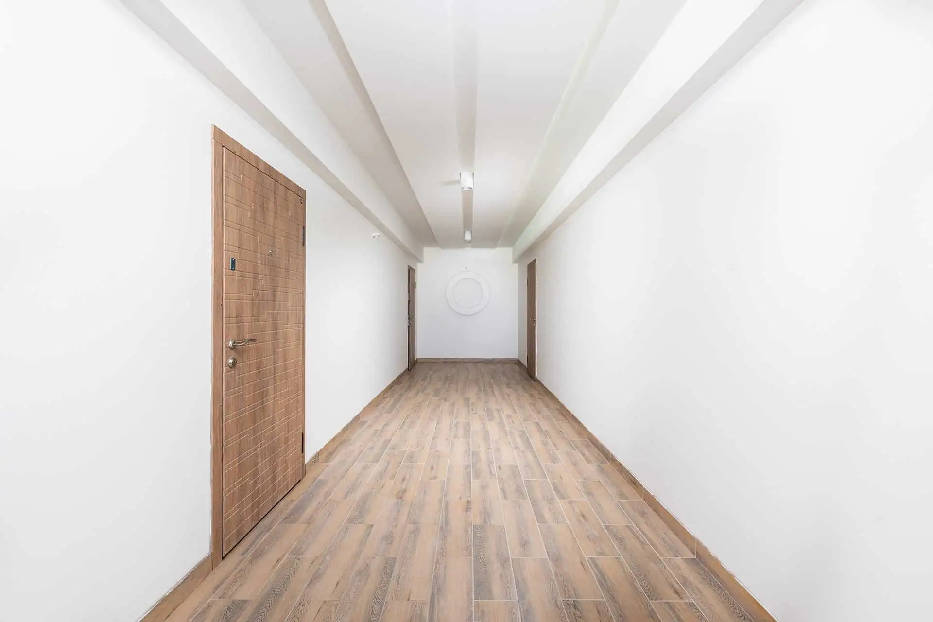 Couloir d’un local professionnel équipé d’un éclairage de plafond à Plaisir